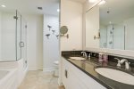 Primary en suite has dual vanities, glass walk-in shower and garden tub. 